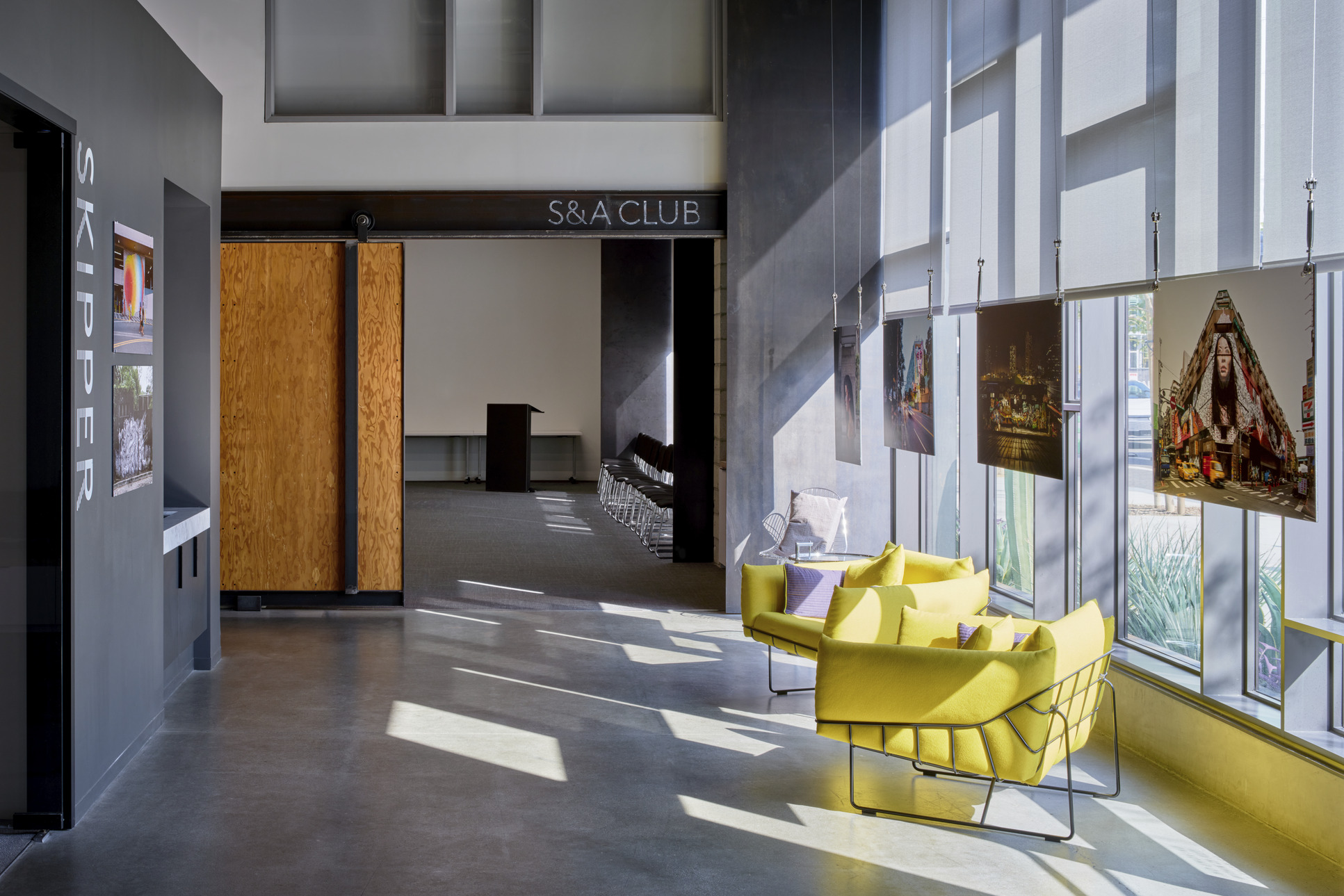 Modern lobby with yellow chairs and natural light.