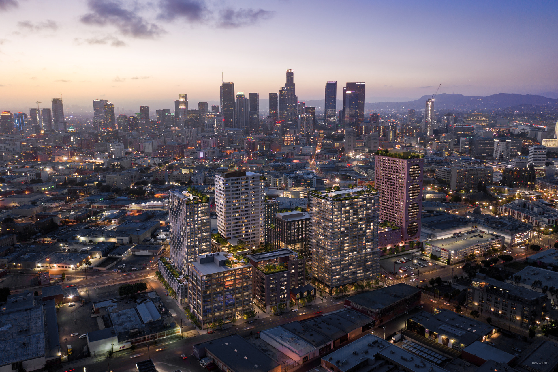A vibrant city skyline at dusk with illuminated buildings and bustling streets.